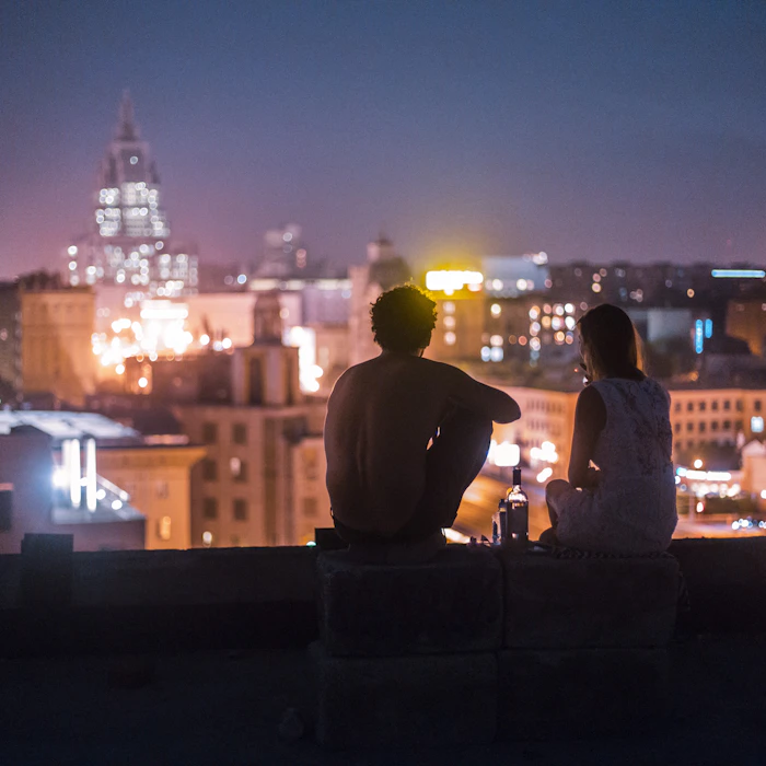 Two friends relaxing on a rooftop in Mumbai
